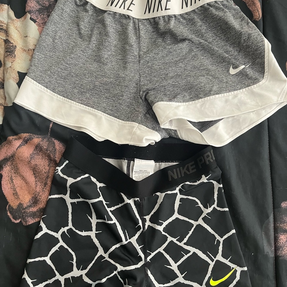 2 pairs of women’s Nike gym shorts. Gray gym shorts and black compression shorts